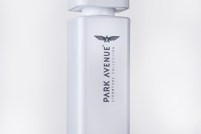 Park Avenue Voyage perfume bottle styled on white fabric, shot by a product photography studio in Jaipur